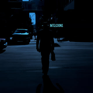 Man walking down a dark city street