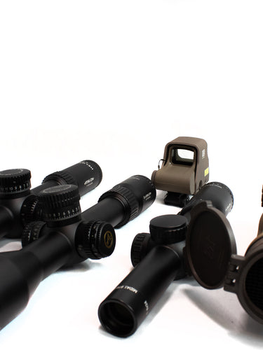 Image of advanced rifle optics, featuring magnified scopes and reflex sights, engineered for enhanced clarity, precision, and rugged use in shooting and tactical environments.